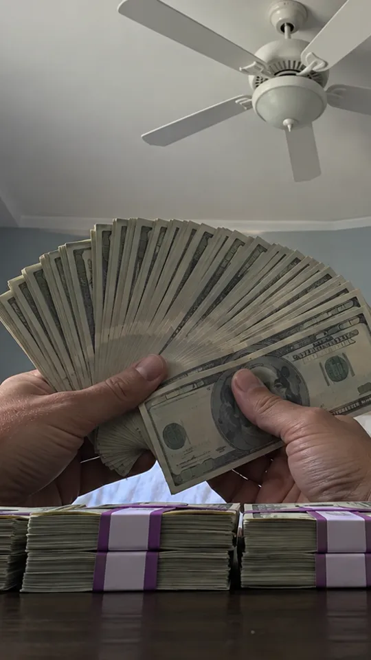 Money Flex AI video: a person holding a fan of cash in front of the camera